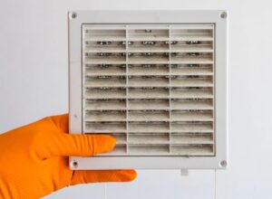 technician shows effects of dirty air ducts need cleaning
