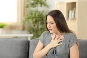 woman having trouble breathing asthma