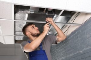 hvac technician inspecting air ducts